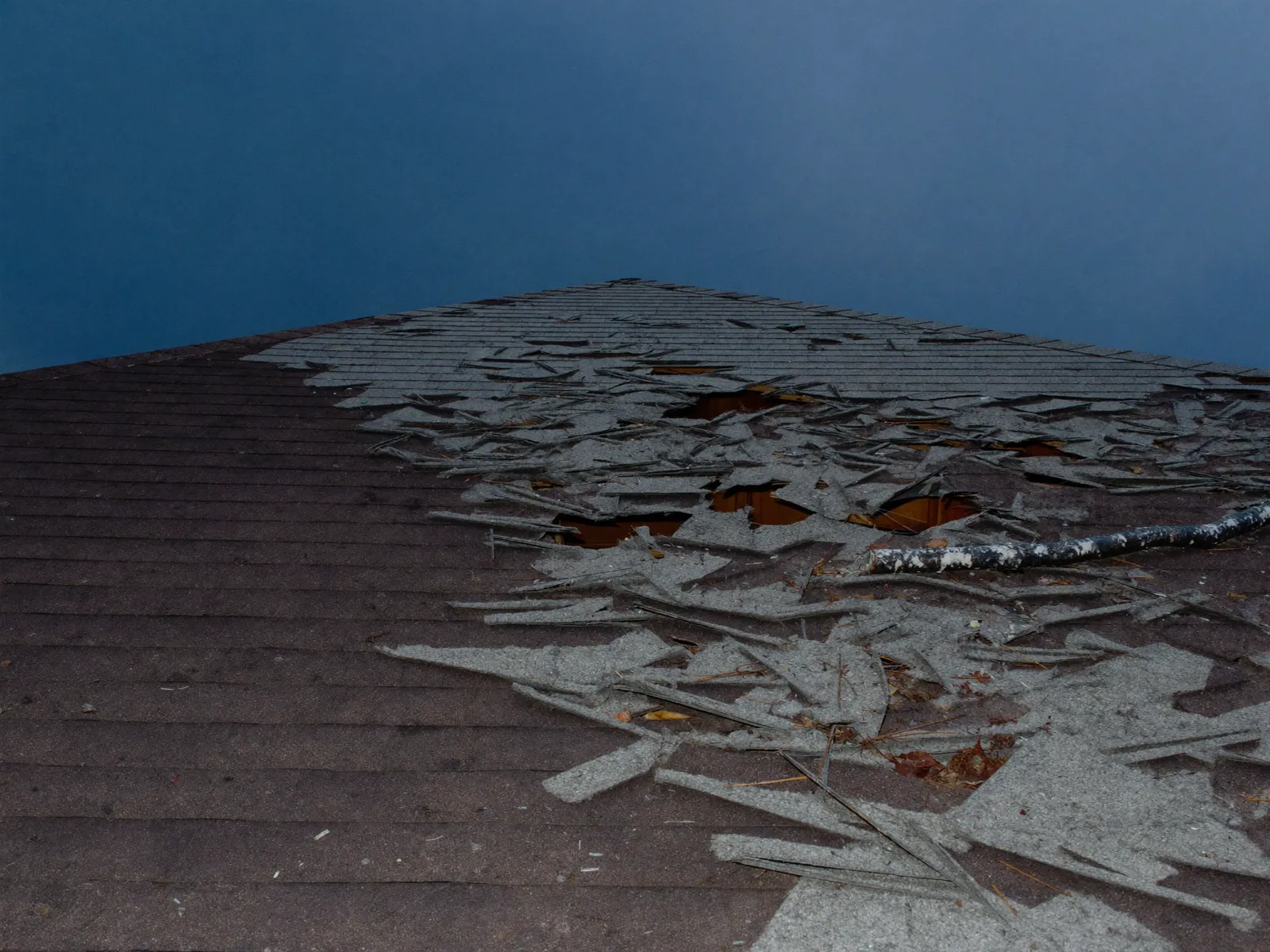 A North Carolina roof with visible storm and hail damage after a passing storm